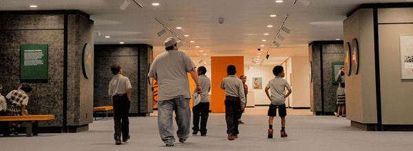 New Lighting at the New York State Museum in Albany A man and several boys walk into the well-lit exhibit area at the New York State Museum in Albany