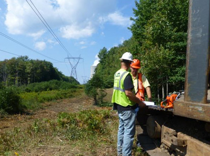 Chris Sherwood, regional staff forester, New York Power Authority (NYPA), at right, reviewing work plans during vegetation maintenance work along a 345kv transmission line in upstate New York, with Kris Lee, foreman, Lewis Tree Service, a firm that NYPA contracts with to assist with its right-of-way efforts.